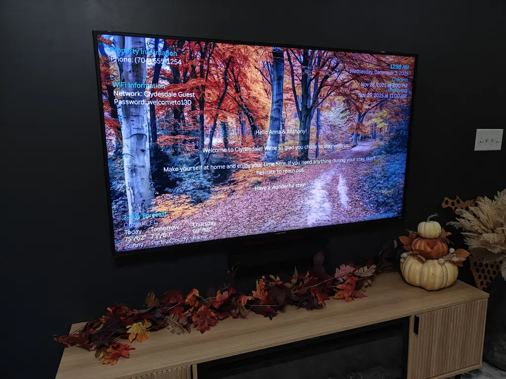 Digital welcome sign for vacation rental displayed on TV showing WiFi and guest greeting
